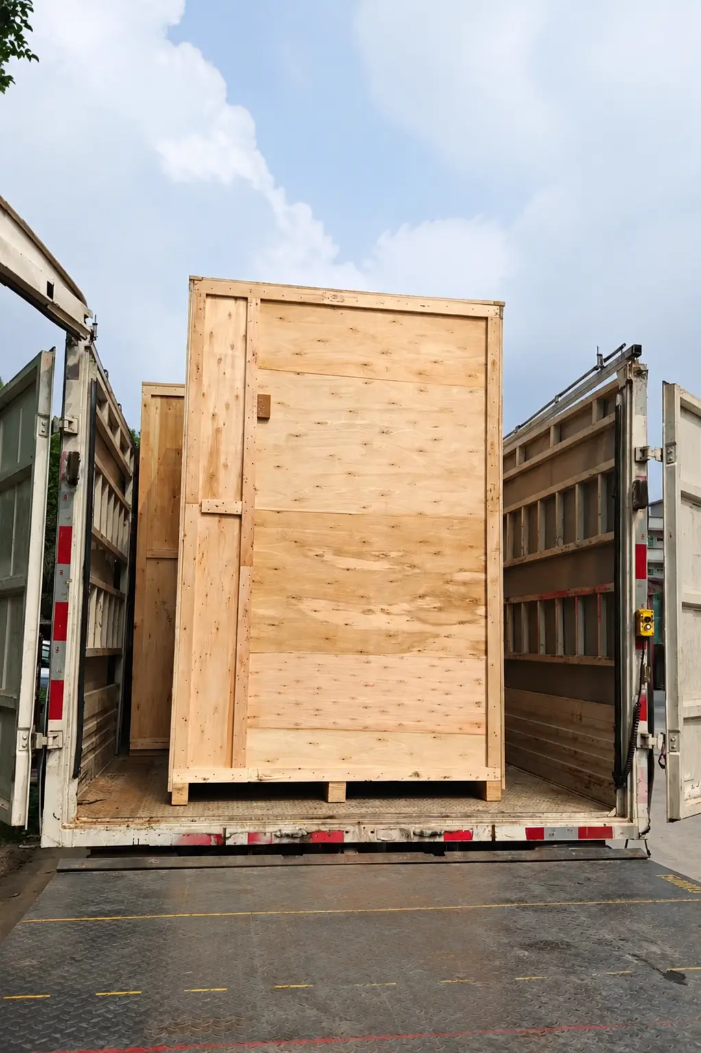 Wooden-crate packaging for the custom pod shell loaded into a truck