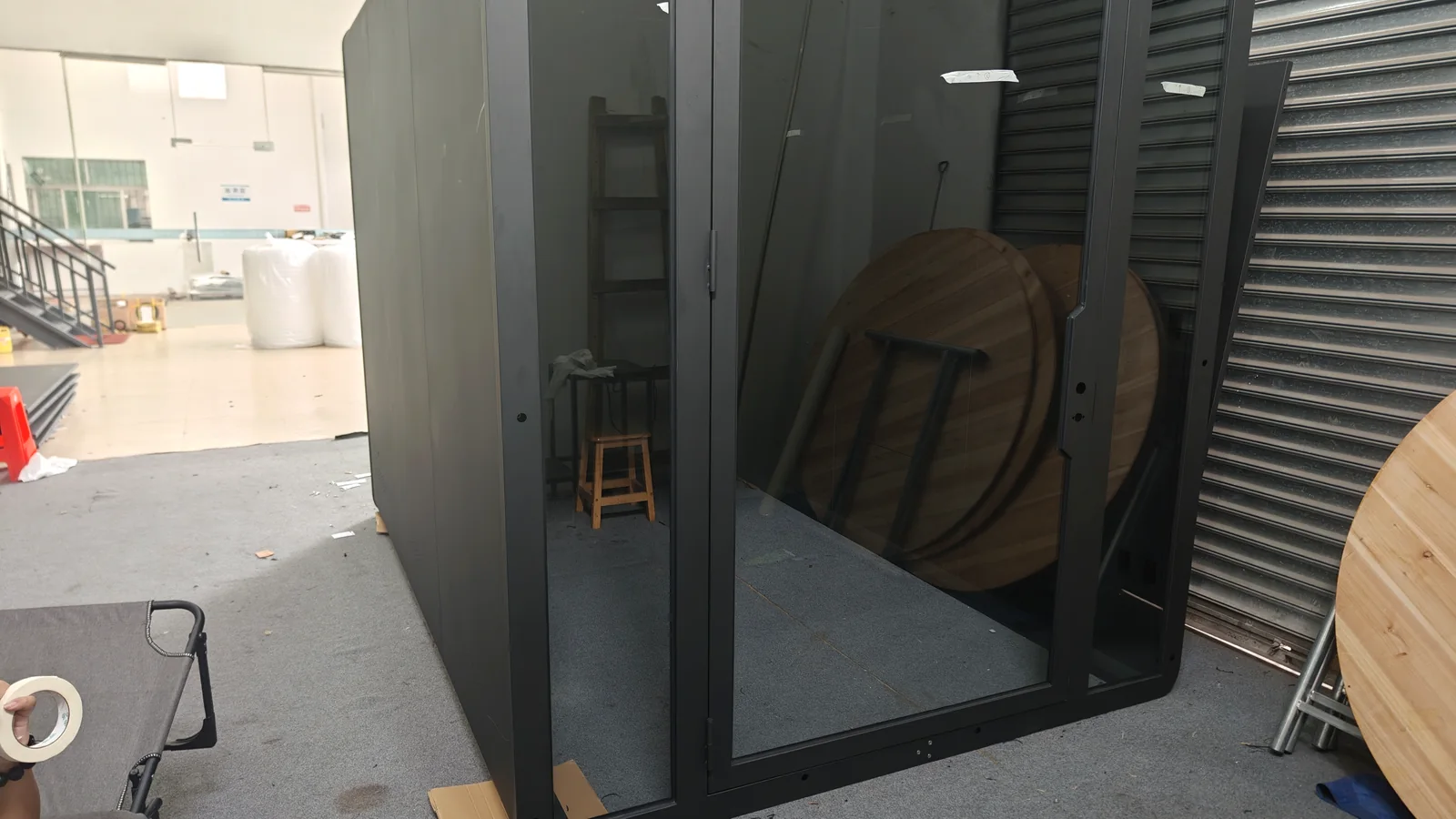 Unfinished custom pod shell with entrance frame during factory assembly
