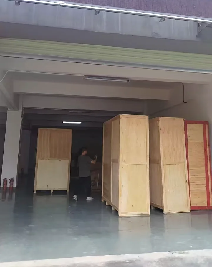 Closed wooden office pod crates at a designated warehouse receiving area