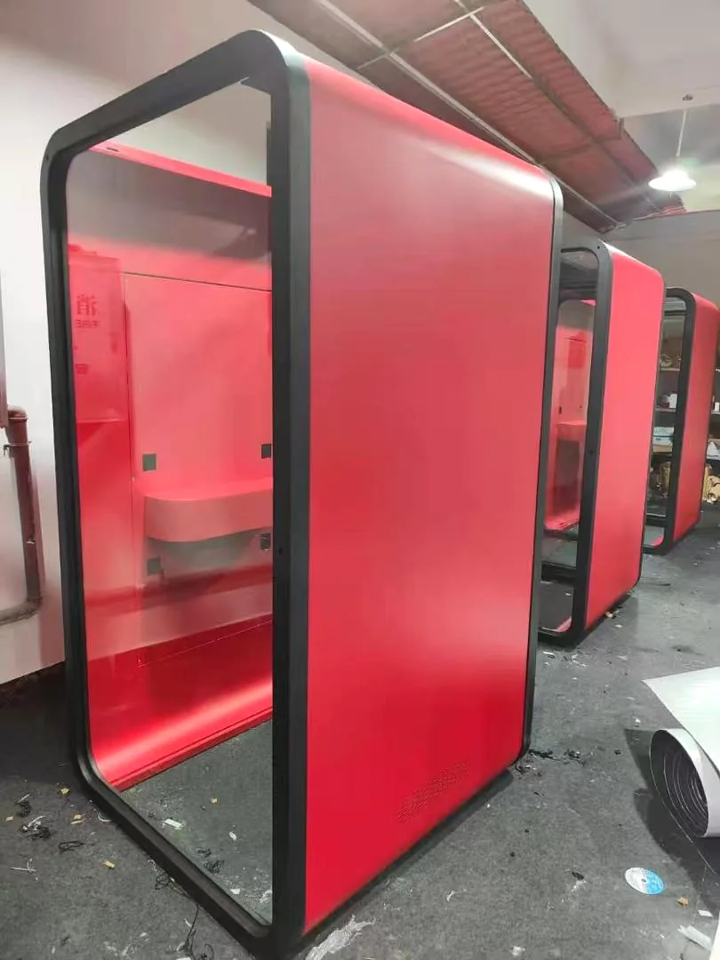 Red pod exterior meeting a black front frame during factory assembly