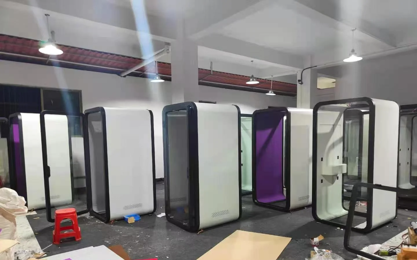 White pod shells with black frames and different visible interior colors in the factory