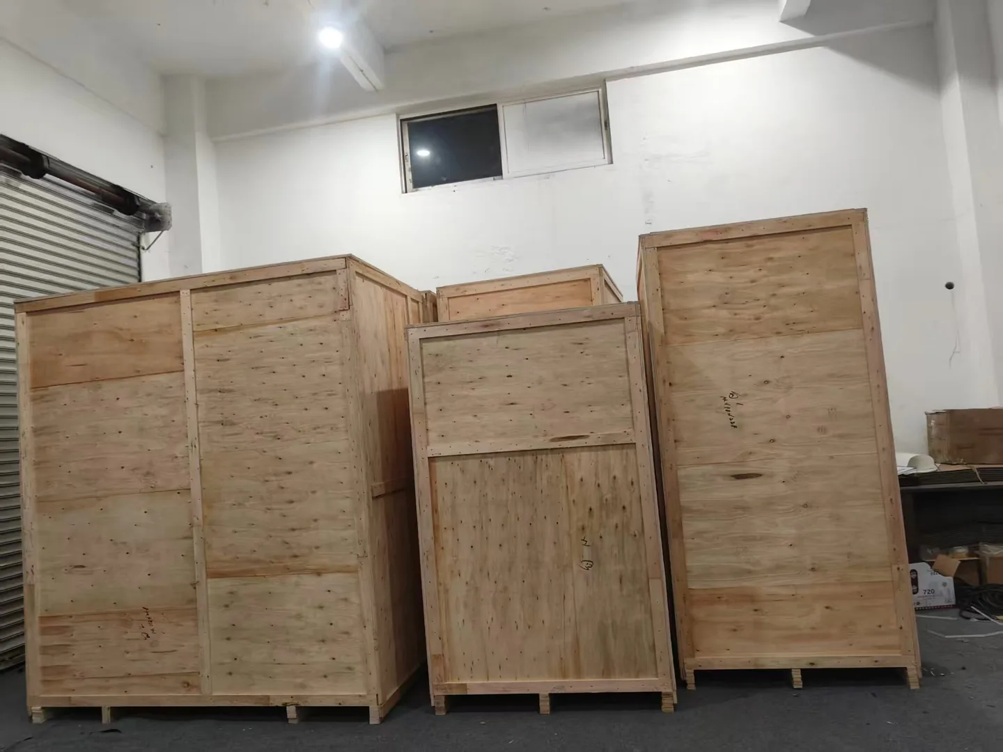 Wooden packing crates of different sizes standing in a storage area